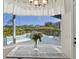 Dining area with bay window offering pool view and a modern table with clear chairs at 7453 Featherstone Blvd, Sarasota, FL 34238