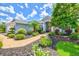 Home exterior showcasing lush landscaping, a brick walkway, and a welcoming entrance at 7453 Featherstone Blvd, Sarasota, FL 34238