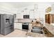 Close up of kitchen with granite counters, stainless appliances, and pendant lighting fixtures at 7453 Featherstone Blvd, Sarasota, FL 34238