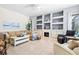 Comfortable living room with built-in shelving, fireplace, and plenty of natural light at 7453 Featherstone Blvd, Sarasota, FL 34238