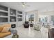 Bright living room with fireplace, built-in shelving, and sliding glass doors leading to outdoor space at 7453 Featherstone Blvd, Sarasota, FL 34238