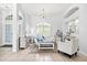 Inviting living room featuring neutral tile floors, and natural light from a large window at 7453 Featherstone Blvd, Sarasota, FL 34238