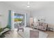 Bright living room featuring neutral decor and sliding doors with a view of the pool at 7453 Featherstone Blvd, Sarasota, FL 34238