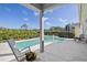 Inviting pool and spa combination with a view of the well-manicured landscaping in the backyard at 7453 Featherstone Blvd, Sarasota, FL 34238