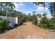 Private gated entry to a secluded tropical property at 7536 Midnight Pass Rd, Sarasota, FL 34242