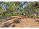 Ranch home nestled amongst mature trees, showcasing a tranquil front yard at 7536 Midnight Pass Rd, Sarasota, FL 34242