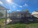 Backyard view of house with solar panels and patio at 7561 120Th Ave, Largo, FL 33773