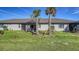 Large backyard with grassy area and palm trees at 7590 Summerland Cv, Bradenton, FL 34202