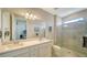 Double vanity bathroom with a large shower and modern fixtures at 7590 Summerland Cv, Bradenton, FL 34202