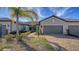 Front view of a two-car garage home with a nicely landscaped walkway leading to the entrance at 7590 Summerland Cv, Bradenton, FL 34202