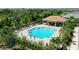 Community pool with lounge chairs and covered seating at 7590 Summerland Cv, Bradenton, FL 34202