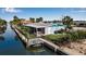 Aerial view of waterfront home with private dock and lush landscaping at 765 Saint Judes N Dr, Longboat Key, FL 34228