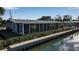 Backyard features a screened enclosure, canal views, and private dock at 765 Saint Judes N Dr, Longboat Key, FL 34228