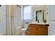 Clean bathroom with tub shower combo, vanity, and window at 8219 Abalone Loop, Parrish, FL 34219