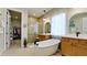 Spa-like bathroom with a large soaking tub, walk-in shower, and double vanity at 8219 Abalone Loop, Parrish, FL 34219