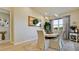 Bright dining room features a wood table with seating for six and an attractive chandelier at 8219 Abalone Loop, Parrish, FL 34219