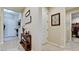 Inviting entryway with console table and access to laundry and closets at 8219 Abalone Loop, Parrish, FL 34219