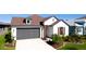 Exterior view of charming one-story home with gray garage door at 8219 Abalone Loop, Parrish, FL 34219