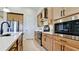 Modern kitchen with stainless steel appliances and light wood cabinets at 8219 Abalone Loop, Parrish, FL 34219