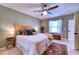 King bedroom with ceiling fan and large windows, offering ample natural light at 8260 47Th Street E Cir, Palmetto, FL 34221