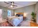 Main bedroom with a king-size bed, ceiling fan, and en-suite bathroom at 8260 47Th Street E Cir, Palmetto, FL 34221