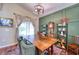 Dining room with a large wooden table and green accent wall at 8260 47Th Street E Cir, Palmetto, FL 34221