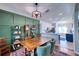 Charming dining room with wood table and green accent wall at 8260 47Th Street E Cir, Palmetto, FL 34221