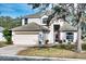 Two-story house with a large garage and landscaped lawn at 8260 47Th Street E Cir, Palmetto, FL 34221