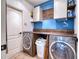 Laundry room with washer, dryer, and custom wood shelving at 8260 47Th Street E Cir, Palmetto, FL 34221