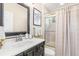 Simple bathroom with single vanity, shower, and linen closet at 8624 Woodbriar Dr, Sarasota, FL 34238