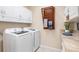 Laundry room with washer, dryer, and ample counter space at 8624 Woodbriar Dr, Sarasota, FL 34238