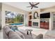 Living room featuring a fireplace, built-in cabinetry and pool view at 8624 Woodbriar Dr, Sarasota, FL 34238