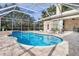 Inviting pool area with covered patio and spacious decking at 8624 Woodbriar Dr, Sarasota, FL 34238