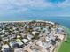 A neighborhood aerial view shows home's location near the bay, and beautiful landscaping at 866 N Shore Dr, Anna Maria, FL 34216