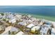 Aerial shot showcasing the home's location near the bay, tropical landscaping, and neighborhood at 866 N Shore Dr, Anna Maria, FL 34216