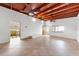 Spacious living room featuring tile floors, wood ceiling, and fans at 866 N Shore Dr, Anna Maria, FL 34216