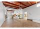 Spacious living room featuring tile floors, wood ceiling, and fans at 866 N Shore Dr, Anna Maria, FL 34216