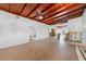 Spacious living room featuring tile floors, wood ceiling, and fans at 866 N Shore Dr, Anna Maria, FL 34216