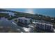 Aerial view of waterfront property with two buildings, pool, and boat docks at 9397 Midnight Pass Rd # 603, Sarasota, FL 34242