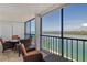 Enjoy this outdoor balcony that features views of the bay, seating for four, and tile flooring at 9397 Midnight Pass Rd # 603, Sarasota, FL 34242