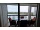 Relaxing balcony with water views and seating for four at 9397 Midnight Pass Rd # 603, Sarasota, FL 34242