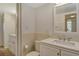 Bright bathroom featuring double sinks and a separate room for toilet and shower at 9397 Midnight Pass Rd # 603, Sarasota, FL 34242