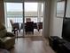 Living room with sliding doors leading to a balcony overlooking the water at 9397 Midnight Pass Rd # 603, Sarasota, FL 34242