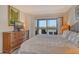 Main bedroom featuring water views and a woven dresser at 9397 Midnight Pass Rd # 603, Sarasota, FL 34242