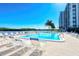 Outdoor pool with lounge chairs overlooking the water at 9397 Midnight Pass Rd # 603, Sarasota, FL 34242