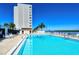 Outdoor pool with lounge chairs with view of a building at 9397 Midnight Pass Rd # 603, Sarasota, FL 34242