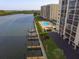 Aerial view of condo complex with a pool, boat docks, and waterfront access at 9397 Midnight Pass Rd # 603, Sarasota, FL 34242