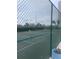 Community tennis court with chain link fence at 9397 Midnight Pass Rd # 603, Sarasota, FL 34242