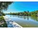 Waterfront view featuring paddleboarders and a dock with boats at 9397 Midnight Pass Rd # 603, Sarasota, FL 34242