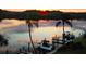 Scenic waterfront view at sunrise, with boats docked at private piers at 9397 Midnight Pass Rd # 603, Sarasota, FL 34242